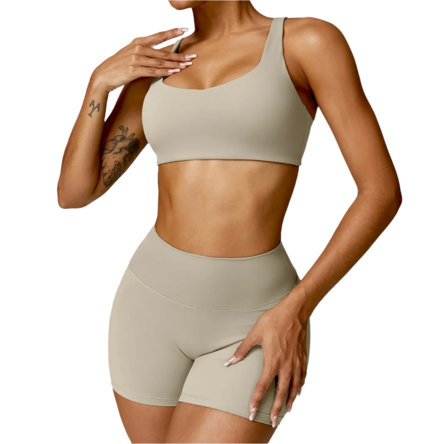 Person wearing a beige sports bra and shorts set on a light background