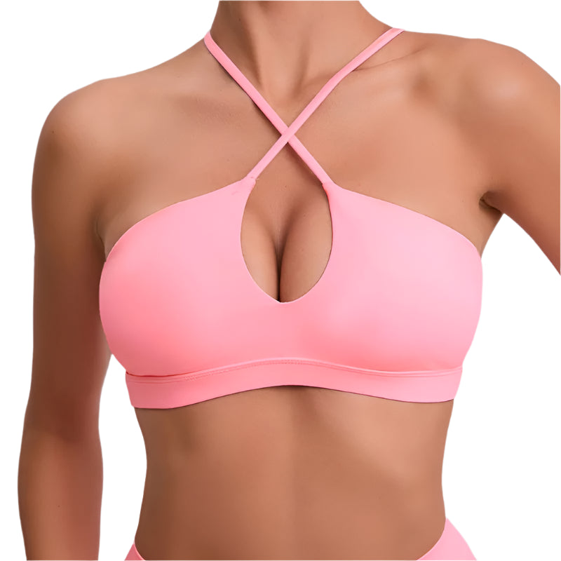 Pink sports bra with criss-cross straps on a gray background, featuring the brand 'STOUREG'.