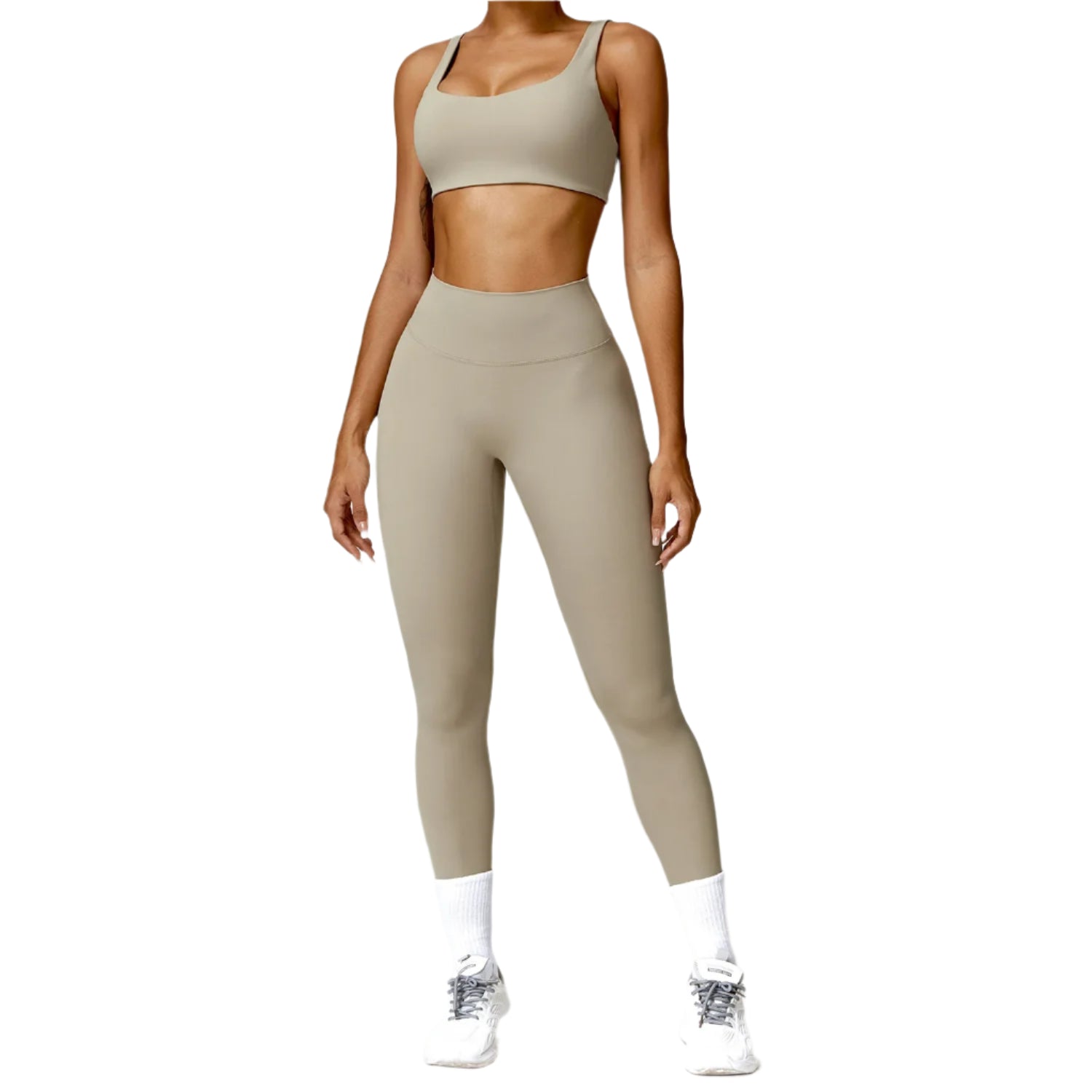 Person wearing a beige sports bra and leggings set on a white background