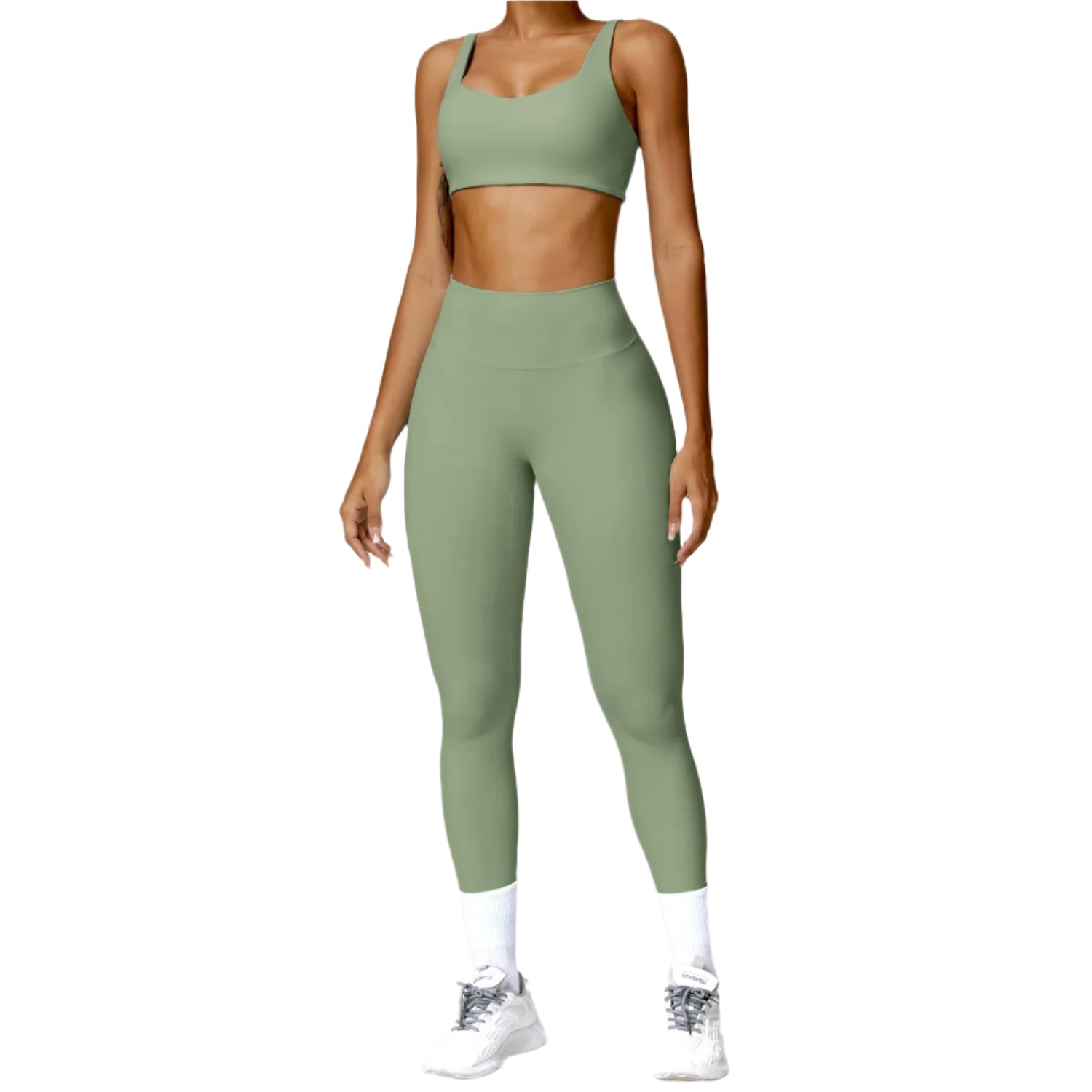 Person wearing a green sports bra and leggings set on a white background