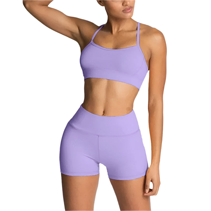 Person wearing a purple sports bra and shorts set on a light gray background
